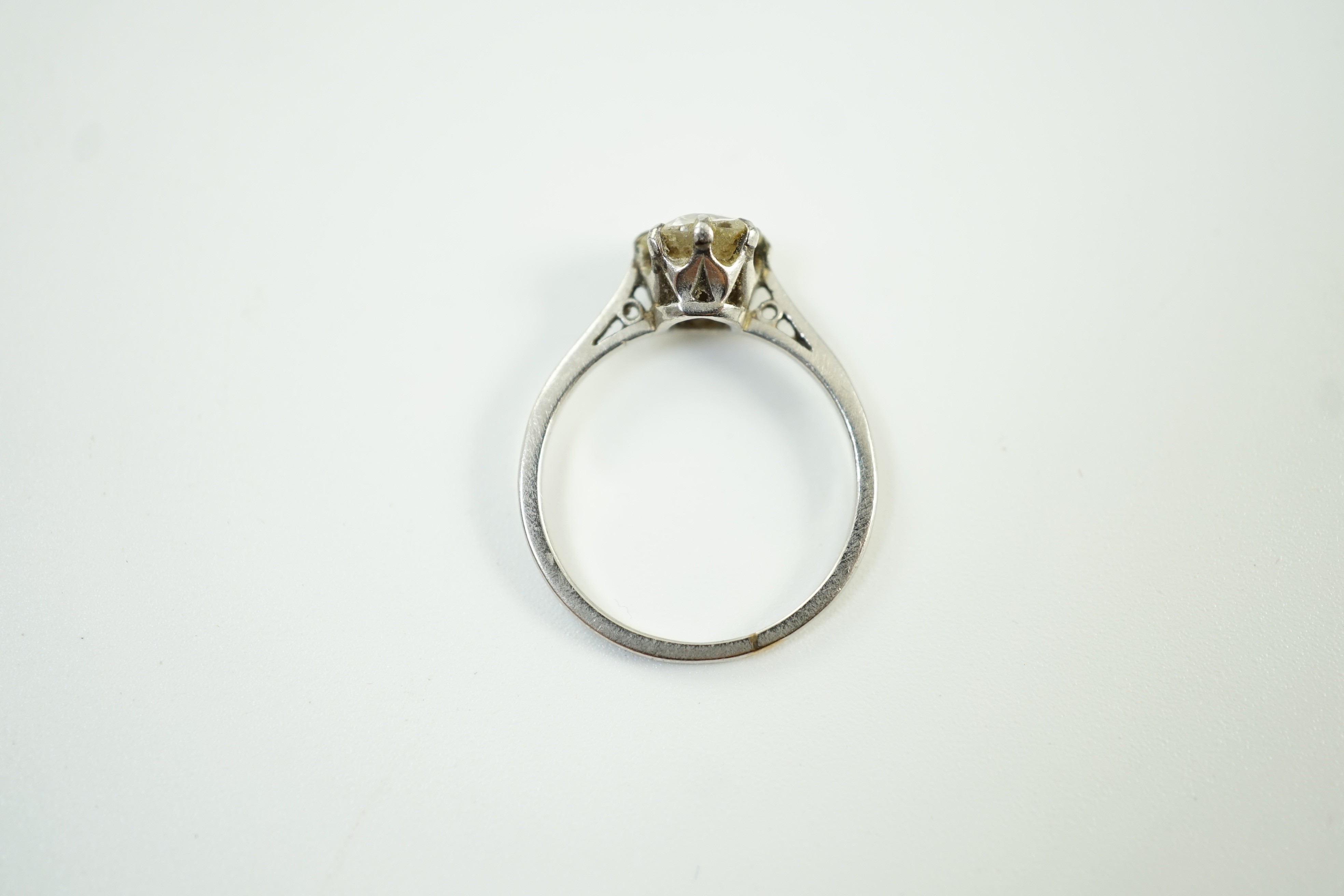 A white metal (stamped plat) and solitaire diamond ring, size J, gross weight 2.6 grams